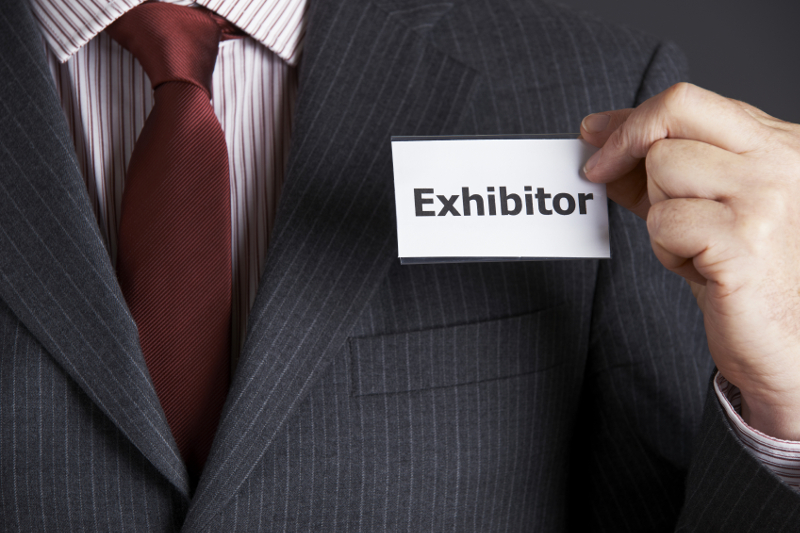 Businessman Attaching Exhibitor Badge To Jacket, exhibitors, trade show, event, exhibit, exhibition, expo, tradeshow,