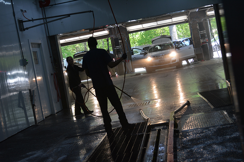 carwash tunnel, cars, car doors, hoses, employees, cleaning, hosing, detailing