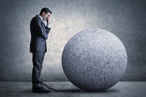 businessman, ball and chain, weight, held back, frustrated