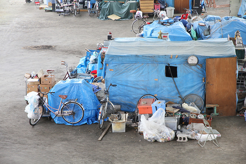 homeless encampment, tents, bicycles, junk, trash