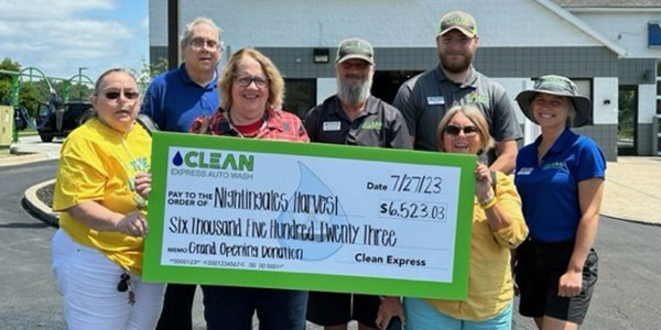 The newest Clean Express team in Lambertville, Michigan, presents the check to Nightingales Harvest.