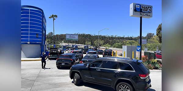 Cars line up for their free carwash during an annual Soapy Joe's Day celebration.