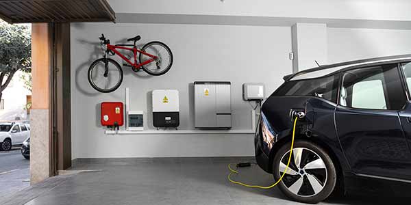 charging electric vehicle at home in garage